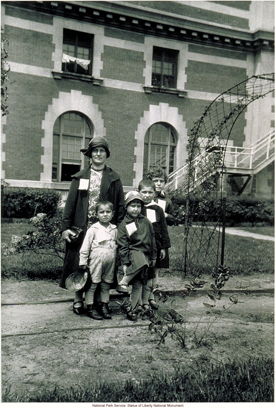 Mother and children, with tags, at Ellis Island