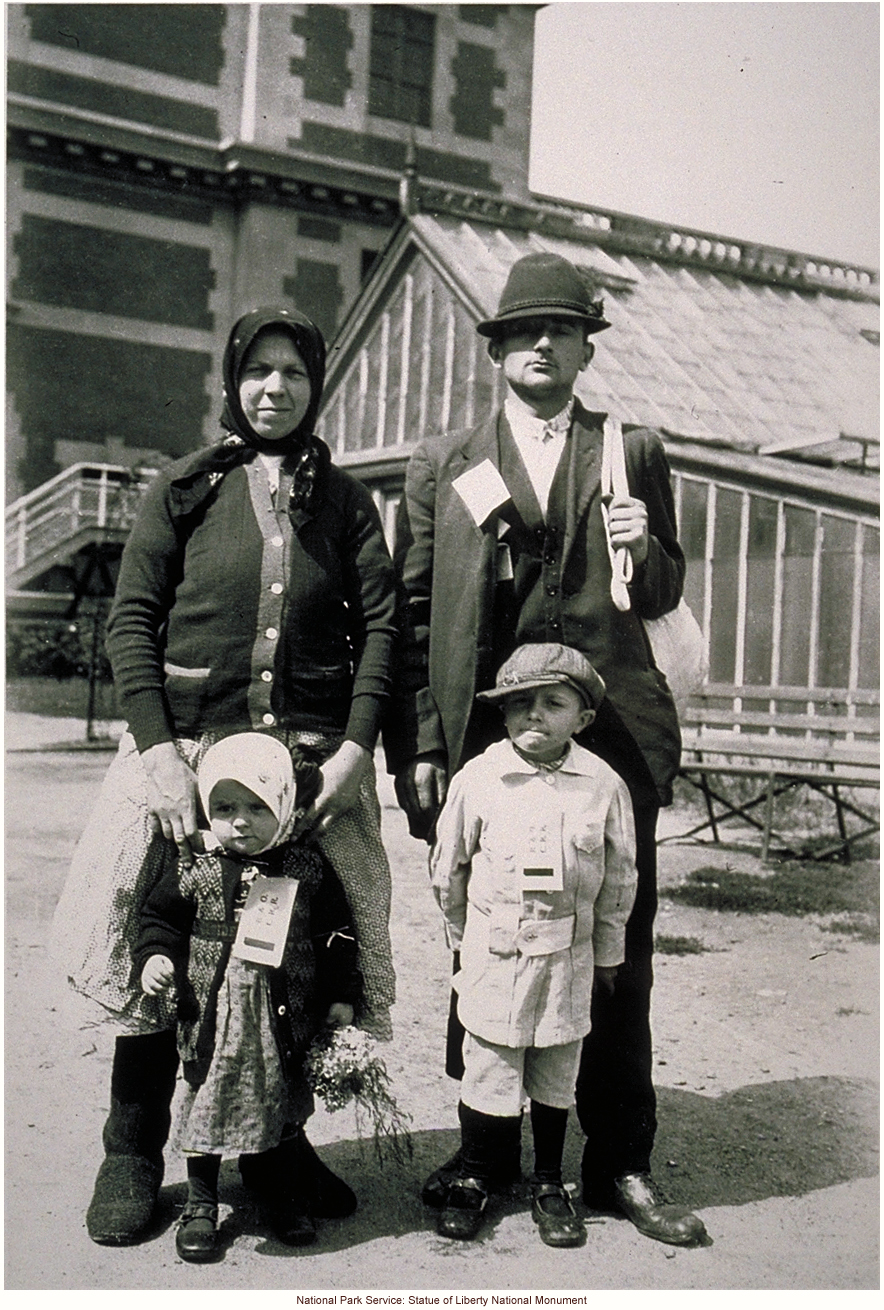 Immigrant family, with tags, at Ellis Island