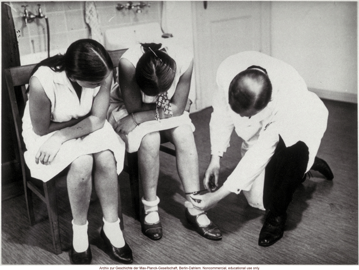 16-year-old female twins undergoing anthropometric study by Otmar Freiherr von Verschuer