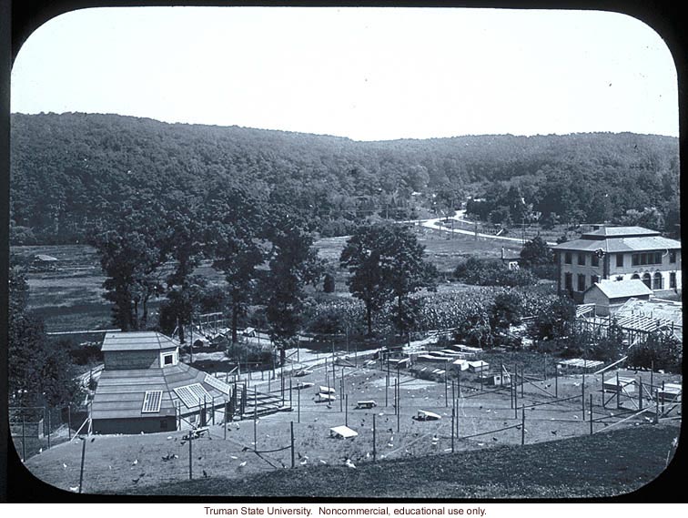 Chicken coops and first hybrid corn (behind) at Carnegie Station for Experimental Evolution, Cold Spring Harbor, N.Y.