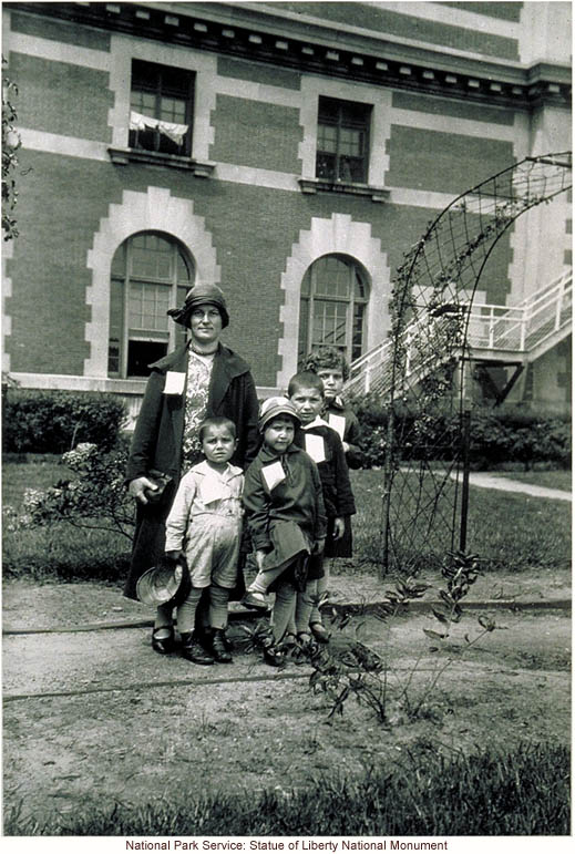 Mother and children, with tags, at Ellis Island