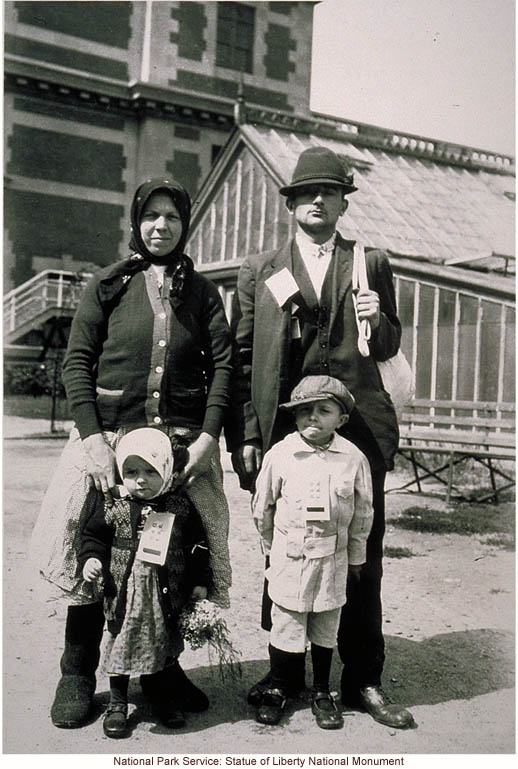 Immigrant family, with tags, at Ellis Island