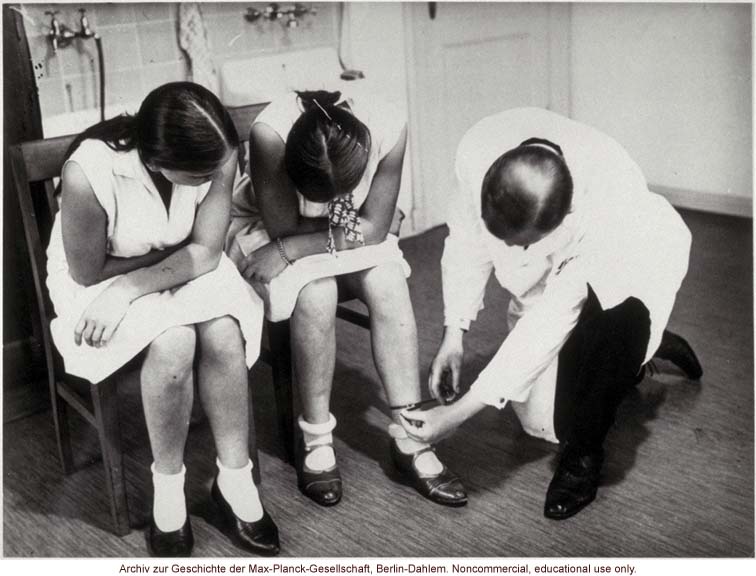 16-year-old female twins undergoing anthropometric study by Otmar Freiherr von Verschuer