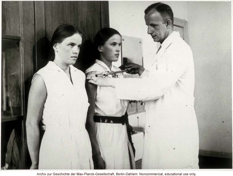 16-year-old female twins undergoing anthropometric study by Otmar Freiherr von Verschuer